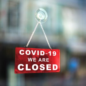 COVID-19 Closed Sign in window of business